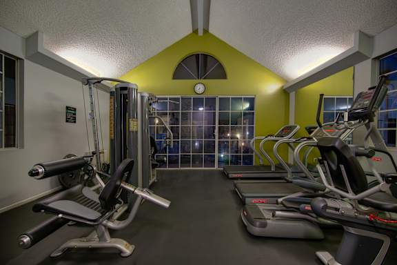 A gym with treadmills and exercise bikes.