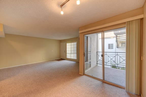 Vacant apartment home showcasing the patio sliding door area leading out to the private balcony