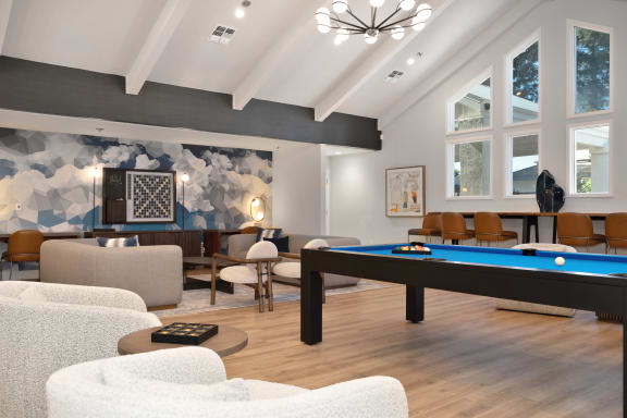 a living room with a pool table and couches  at Track 281 Apartments, Sacramento, CA, 95811