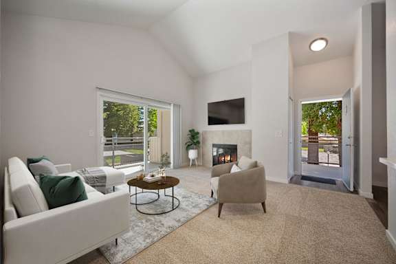 a living room with a couch and a chair and a fireplace