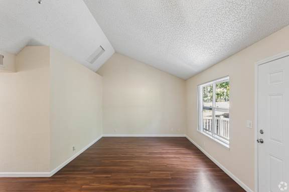 A room with wooden floors and white walls.