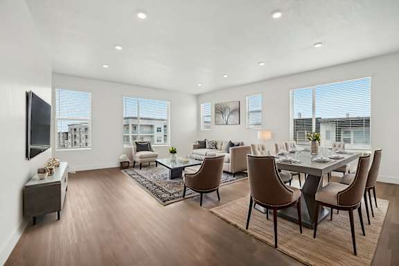 A modern dining room with a large table and chairs.