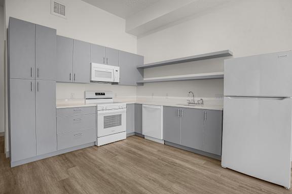 A kitchen with white appliances and cabinets.