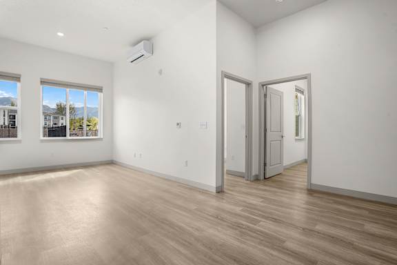 A room with a wooden floor and a sliding door.