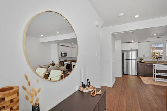 A modern kitchen with a large mirror on the wall.