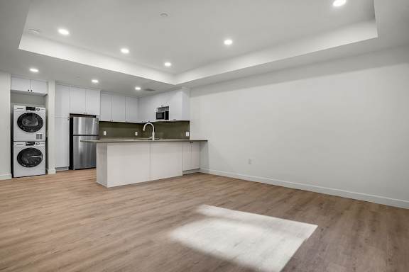 A kitchen with a washer and dryer built in.
