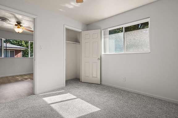 A room with a white door and a window with a white frame.