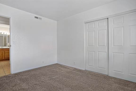 A room with white walls and a carpeted floor.