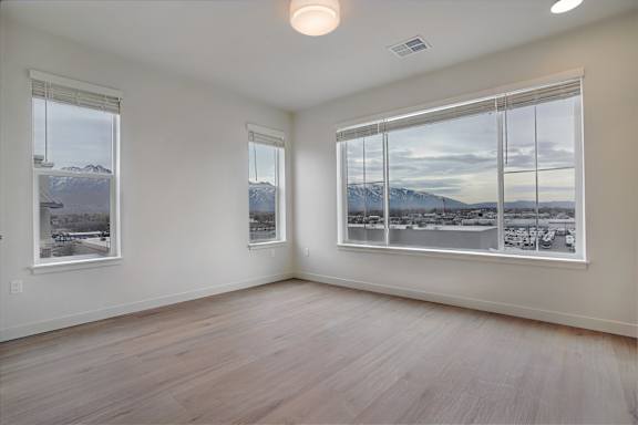 A room with two windows overlooking a snowy landscape.