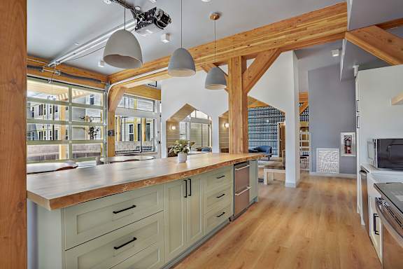 A kitchen with wooden cabinets and a large island.