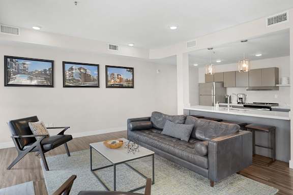 A living room with a grey couch and a coffee table.