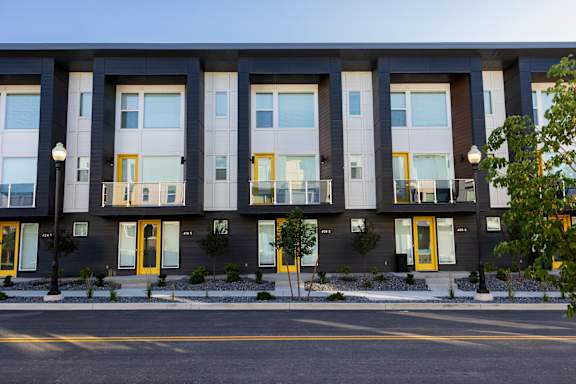 A building with grey walls and yellow doors.