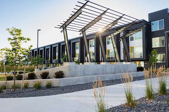 A modern building with a metal roof structure.