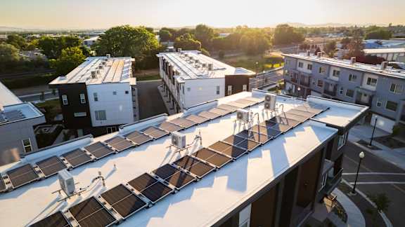 A rooftop with solar panels is seen in the image.