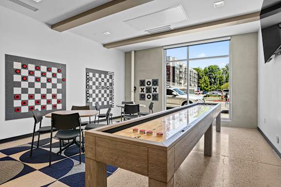 A room with a checkerboard patterned floor and a pool table.