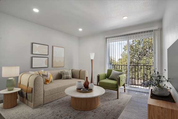 A living room with a couch, a chair, a table, and a lamp.