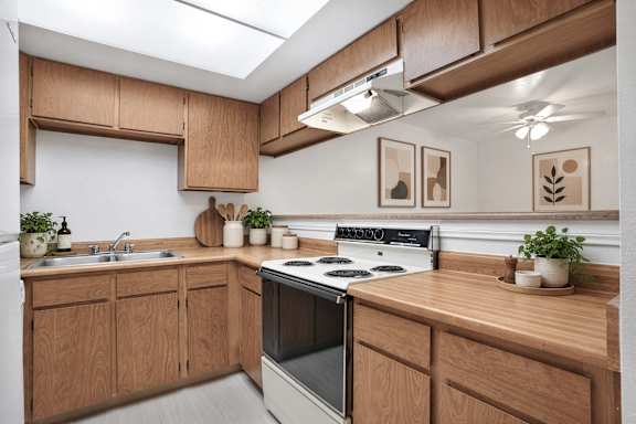 A kitchen with wooden cabinets and a stove top oven.