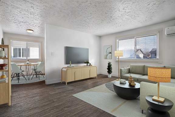 A living room with a television, a sofa, and a coffee table.