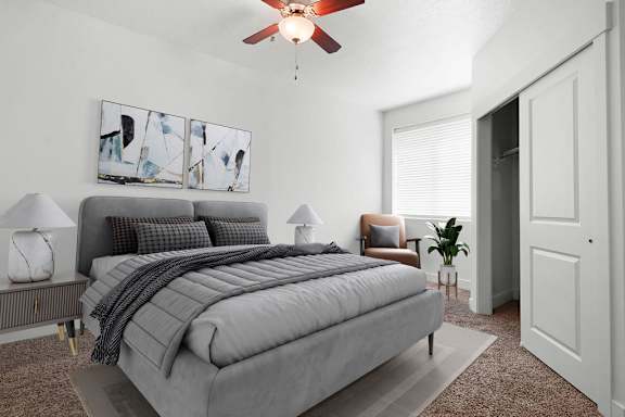 A bedroom with a bed, a chair, and a painting on the wall.