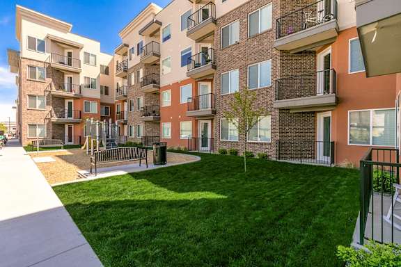 Apartment complex with a green lawn in front.
