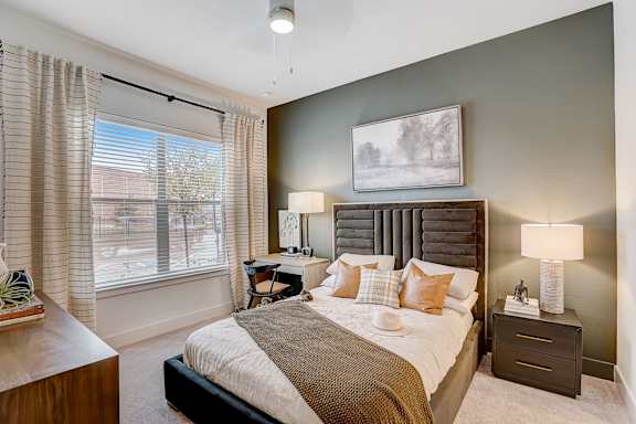 a bedroom with a large bed and a window at The Mill Old Town, Lewisville Texas
