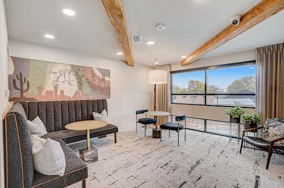 a living room with couches and chairs and a large window