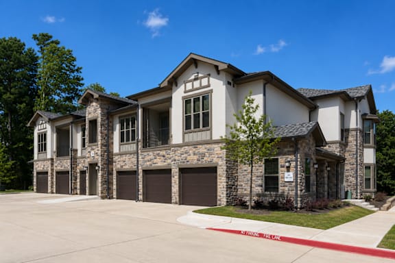 A large, two-story house with a stone facade and a garage.