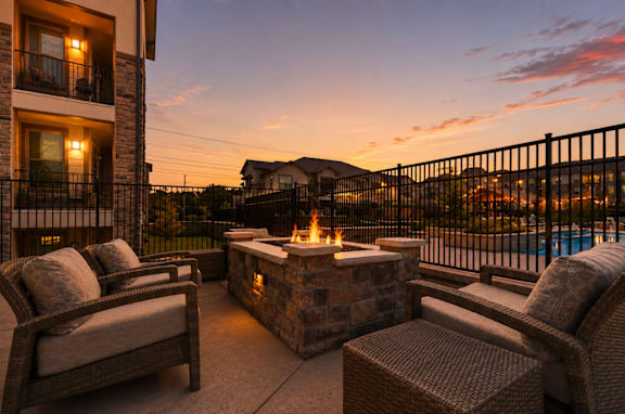 Outdoor fire pit and lounge area at sunset at Auberge of Tyler.