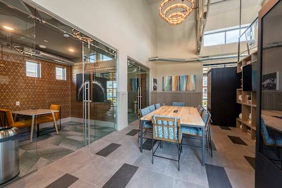 a dining room with a wooden table and chairs and a glass door