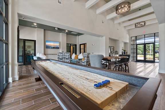 Community shuffleboard in clubhouse at Auberge of Tyler apartments in Tyler TX.