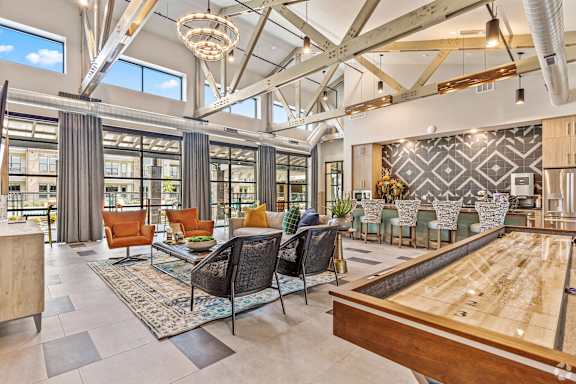 A billiard table is in the middle of a room with a shiny wooden floor.