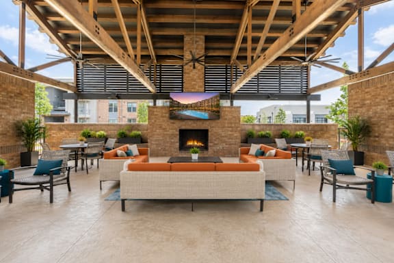 A large open patio with a fireplace and seating area.