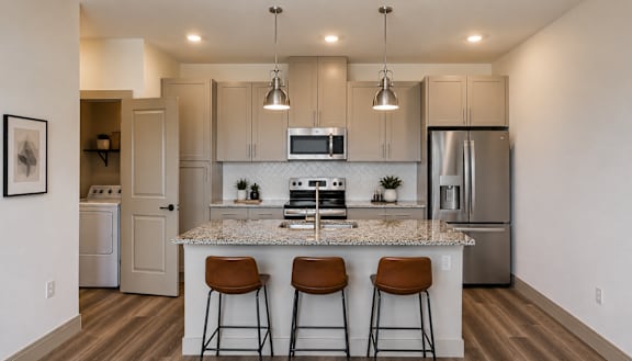 A kitchen with a bar and stools.