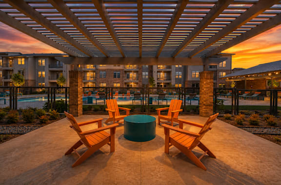 A wooden table and chairs are set up on a patio.