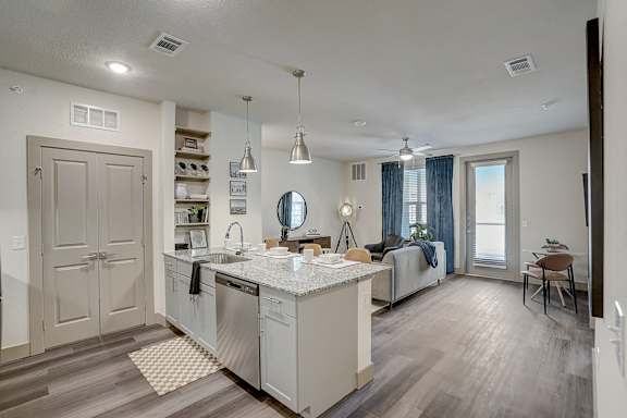 A kitchen with a large island and a dining area.