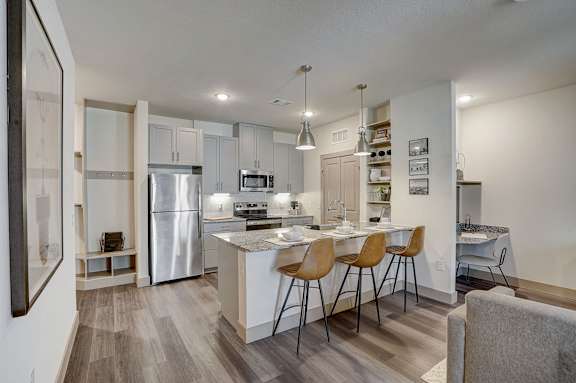 A modern kitchen with a dining table and chairs.