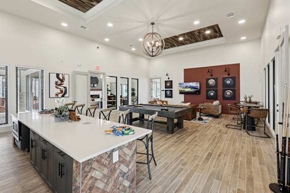Resident lounge with seating and TV at The Westerly Apartments in Midlothian, Texas