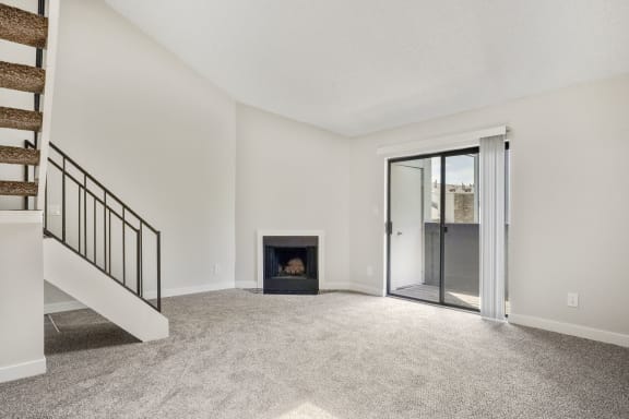 a living room with a fireplace and a staircase  at Hilltop View in Denver, CO