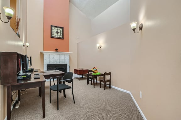 Business Center with a fireplace and a desk with a computer at Horizon East in Aurora