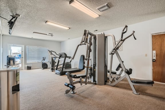 A well-equipped gym with a variety of machines and equipment at Horizon East Apartments in Aurora, CO.