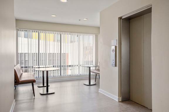 Elevators and a table and chairs at Sleek Lofts Denver Colorado