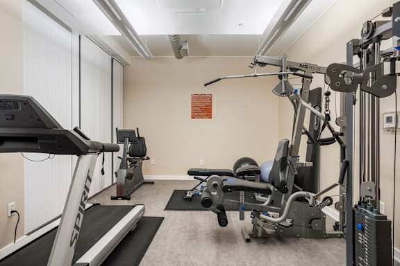 a gym with machines and weights at Sleek Lofts Denver Colorado