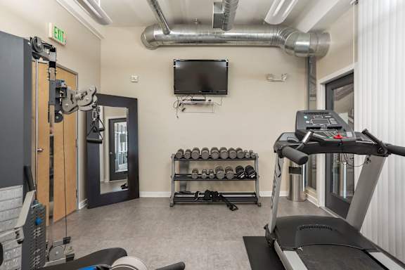 a gym with free weights at Sleek Lofts Denver Colorado