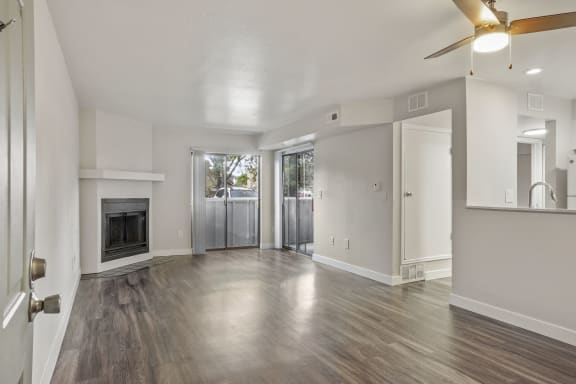a living room with hardwood floors and a fireplace at Horizon East Apartments in Aurora, CO