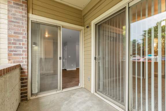 a patio with sliding glass doors  at The Buttes Apartments Loveland, CO