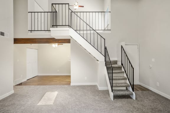 a staircase in a home with carpeted stairs  at Hilltop View in Denver, CO