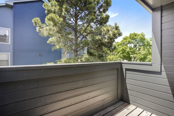 a balcony and a tree in the background  at Hilltop View in Denver, CO
