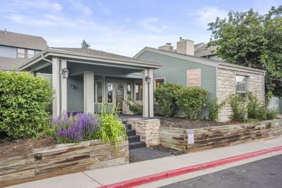 Leasing office with a porch and a sidewalk in front of it  at Hilltop View in Denver, CO