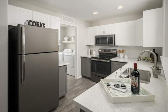 a kitchen with stainless steel appliances and white cabinets at Trevi Apartment Homes, Chandler, 85224