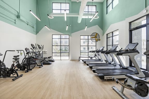 the gym with treadmills and ellipticals at the belgard apartments at The Michael B Townhomes and Flats, Las Vegas Nevada